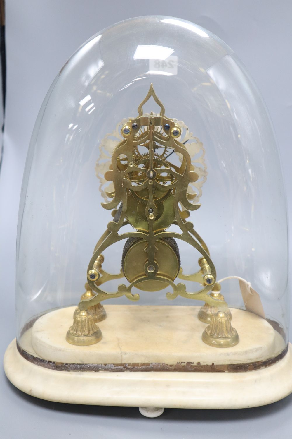 A fusee skeleton clock on marble base, under associated dome, height overall 39cm